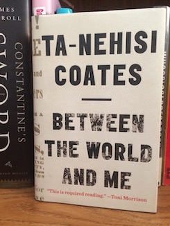 Photo of the book Between the World and Me by Ta-Nehisi Coates on a bookshelf.