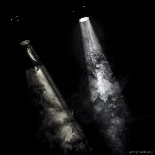 Photo of two stage light beams shining through smoke. Photo by George Katsekes Jr.