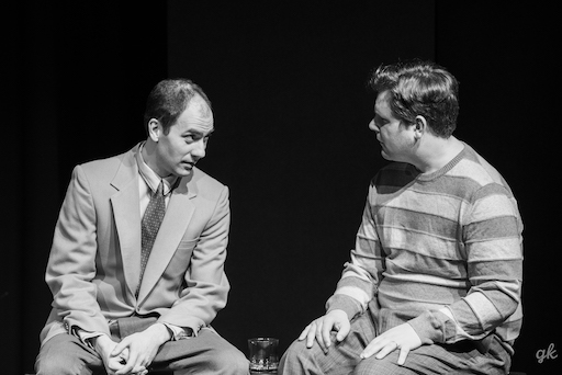 Robert (Matthew Collie) and Jerry sitting and facing each other.